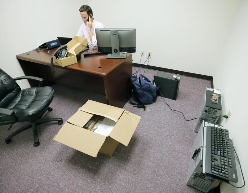 Ky Parker, System Administrator for InterDev, contracted by South Fulton, sets up new phones.